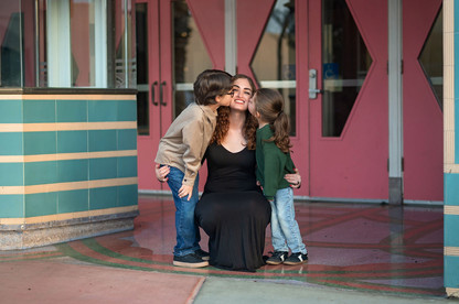Downtown Roseville family photography session at sunset featuring a playful family walking, laughing, and interacting naturally in an urban setting.