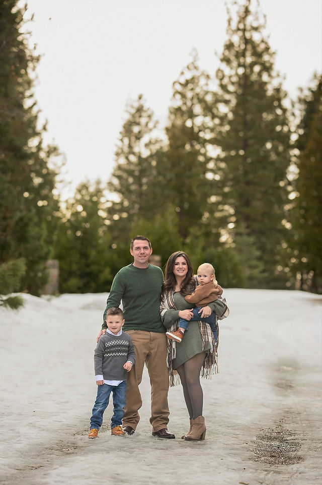 Winter family photos in the snow by best Sacramento family photographer, capturing playful moments, sibling bonds, and the beauty of parenting in Emigrant Gap.