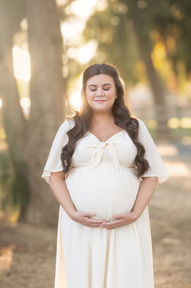 Beautiful summer maternity photoshoot at Gibson Ranch with Valentina, showcasing a glowing mom-to-be in two elegant gowns from the client closet, surrounded by warm sunset light, captured by Sacramento's best photographer, Kristina Martin.