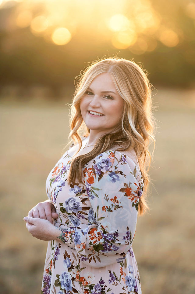 Sacramento family photographer captures a family of three in a local park at sunset with golden dry grass and warm natural tones.