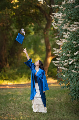 Sacramento high school graduate tossing cap in the air during senior graduation photos