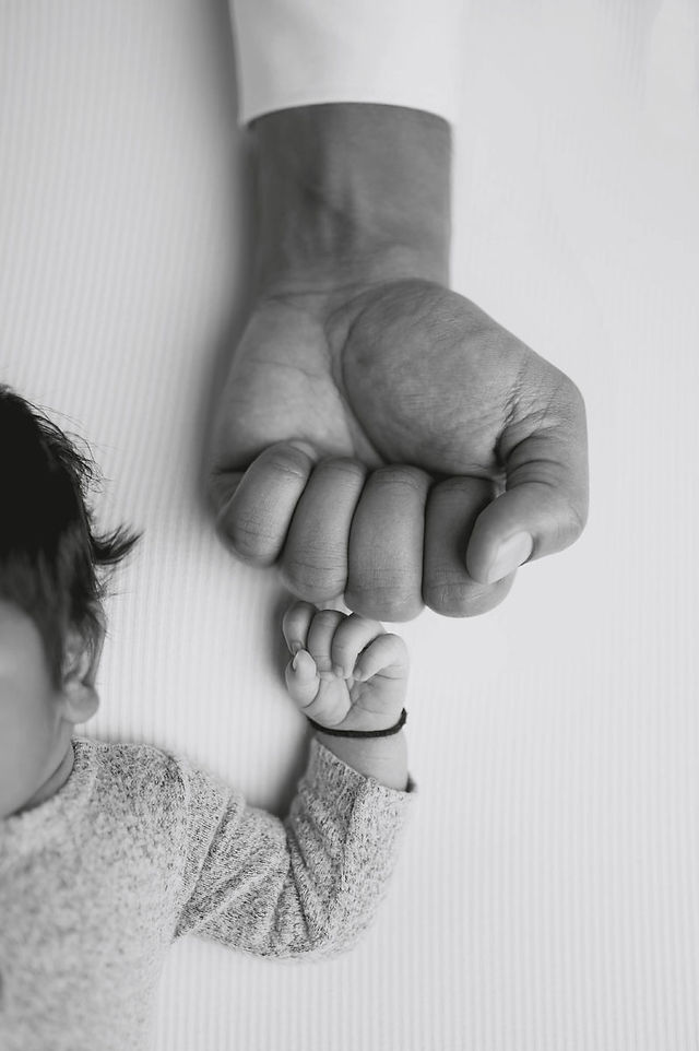 In-home Sacramento newborn photography session featuring family and baby portraits captured in natural light and cozy lifestyle settings.