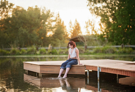 High school senior portraits at a scenic farm in Lincoln, California featuring golden evening light, open fields, waterfront views, swings, and natural outdoor backdrops.