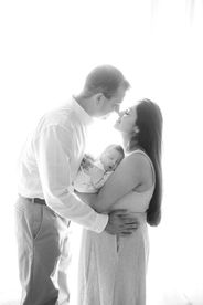 Sweet newborn baby boy peacefully sleeping in a cozy studio setting, wrapped in soft neutrals of cream and white, with delicate details captured like tiny toes, hands, and lashes. Family photos included tender moments with mom and dad. Taken by the best maternity and newborn photographer in Sacramento, Kristina Martin Photography.