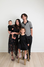 Six month old baby smiling during a milestone session at a Roseville photography studio with simple, clean backdrops.
