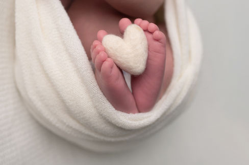 A gallery of newborn session images featuring a swaddled baby in simple, cozy setups. The photos capture a variety of angles, showing the baby peacefully resting in natural, comfortable poses. Some images are taken on a soft white backdrop, while others include a blue background or warm, textured blankets taken by Sacramento Maternity and Newborn photographer Kristina Martin Photography.