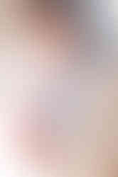 Six month old baby smiling during a milestone session at a Roseville photography studio with simple, clean backdrops.