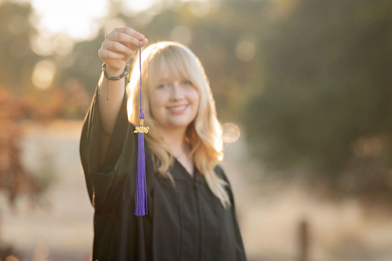 High school senior photographed by Kristina Martin Photography, Sacramento and Roseville senior photographer, in long golden grass during golden hour with soft, wispy light and warm neutral tones.