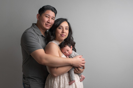 Newborn baby boy captured during a cozy in-home session by Sacramento newborn photographer, showcasing precious moments with family and adorable details.