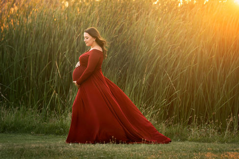 Beautiful maternity photos of Danielle wearing red maternity gown at Gibson Ranch, captured by the best Sacramento maternity photographer Kristina Martin.