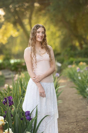 Sacramento family photographer capturing a spring iris farm family session with blooming irises, golden hour light, garden paths, and natural family portraits.