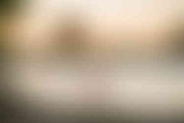 Maternity image of couple embracing in golden dreamy light during her maternity session in Sacramento Ca taken by the best Sacramento Maternity Photographer Kristina Martin