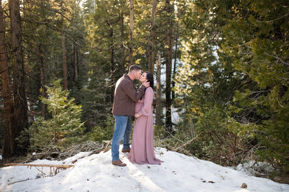 Snowy forest maternity session featuring a couple in soft, romantic colors. Captured by Kristina Martin Photography, best Sacramento maternity and newborn photographer.