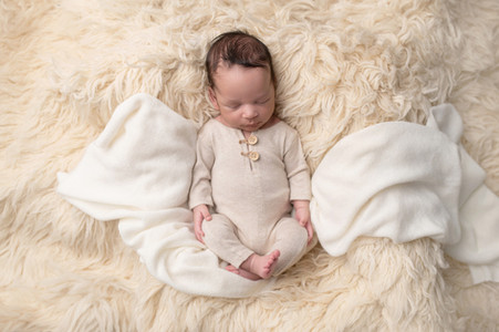 A gallery of newborn session images featuring a swaddled baby in simple, cozy setups. The photos capture a variety of angles, showing the baby peacefully resting in natural, comfortable poses. Some images are taken on a soft white backdrop, while others include a blue background or warm, textured blankets taken by Sacramento Maternity and Newborn photographer Kristina Martin Photography.
