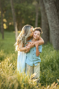 Sacramento family photographer capturing a spring botanical garden first birthday and cake smash session with blooming tulips, teddy bear decor, and natural family portraits.