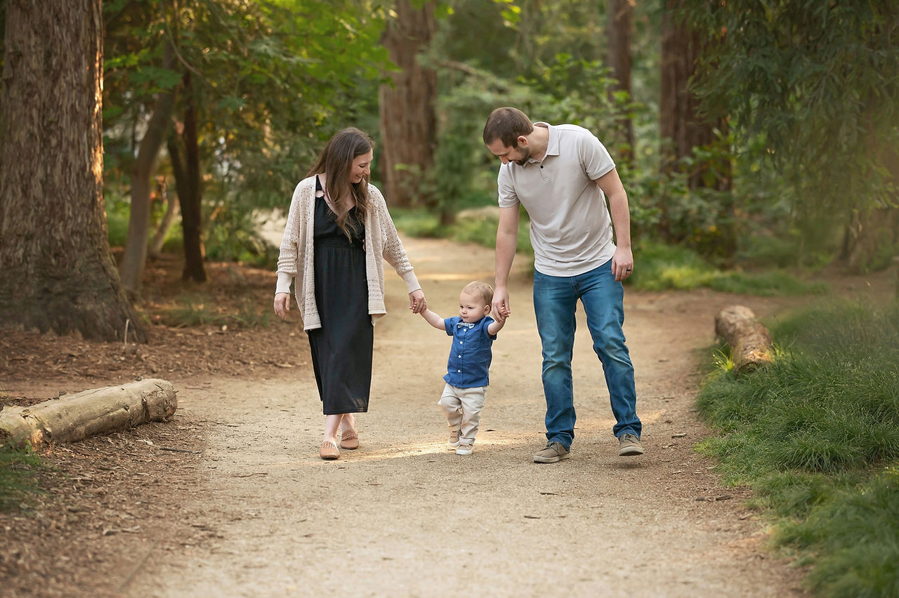 Family with one-year-old at the Davis Arboretum during golden hour, captured by best Sacramento maternity, newborn, and baby photographer and maternity photographer Kristina Martin.