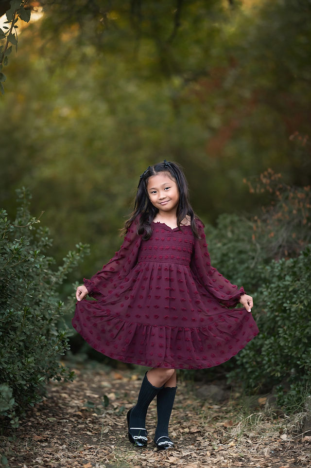 A beautiful family session captured by a Sacramento family photographer at the iris farm, featuring warm fall tones, genuine moments of connection, and golden light.