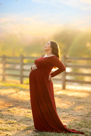 Beautiful maternity photos of Danielle wearing red maternity gown at Gibson Ranch, captured by the best Sacramento maternity photographer Kristina Martin.