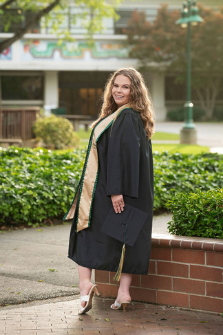 Sacramento senior photographer capturing a Sacramento State graduation session with natural light portraits, blooming roses, green campus walkways, and cap and gown images.