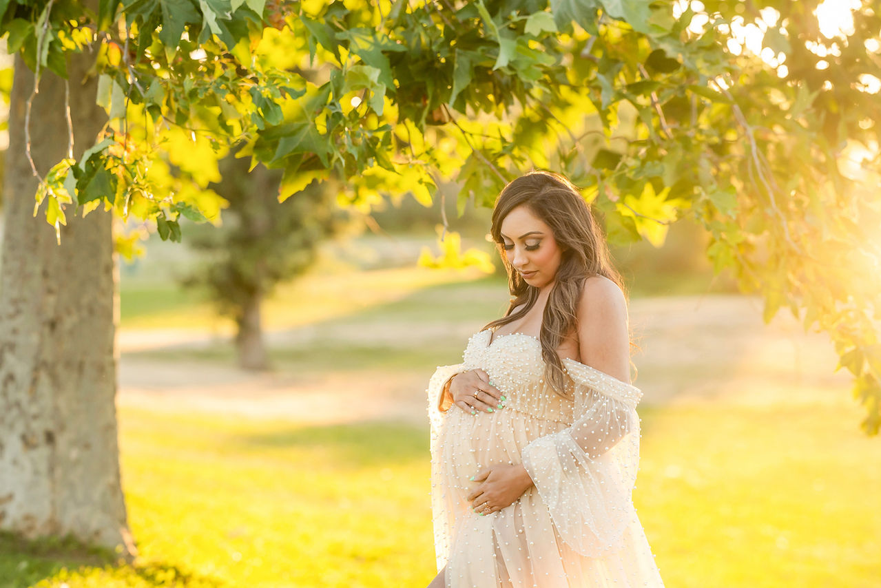 Maternity image of mom-to-be in golden dreamy light during her maternity session in Sacramento Ca taken by the best Sacramento Maternity Photographer Kristina Martin