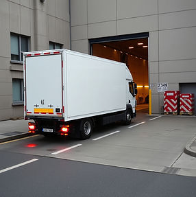 european white truck waiting at the door number at the loading site .jpg