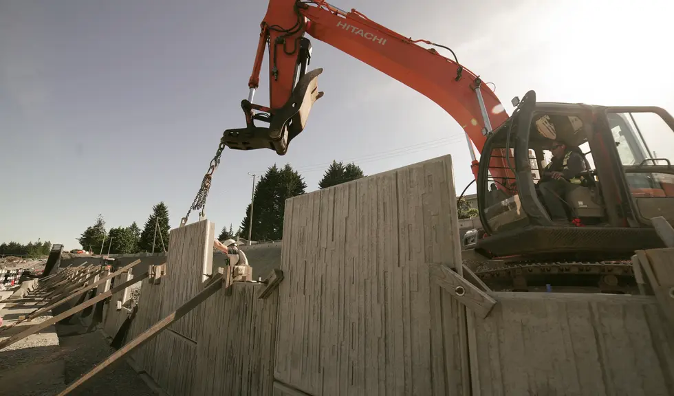 Construction Crew Working on Coastal Wolf Construction Highway Build Project Site with Machinery