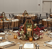 Create a realistic image. Christmas corporate event, in a banquet hall with white basic w