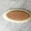 Thumbnail: handmade oval ceramic butter dish with scalloped edge and embossed pine cone pattern.