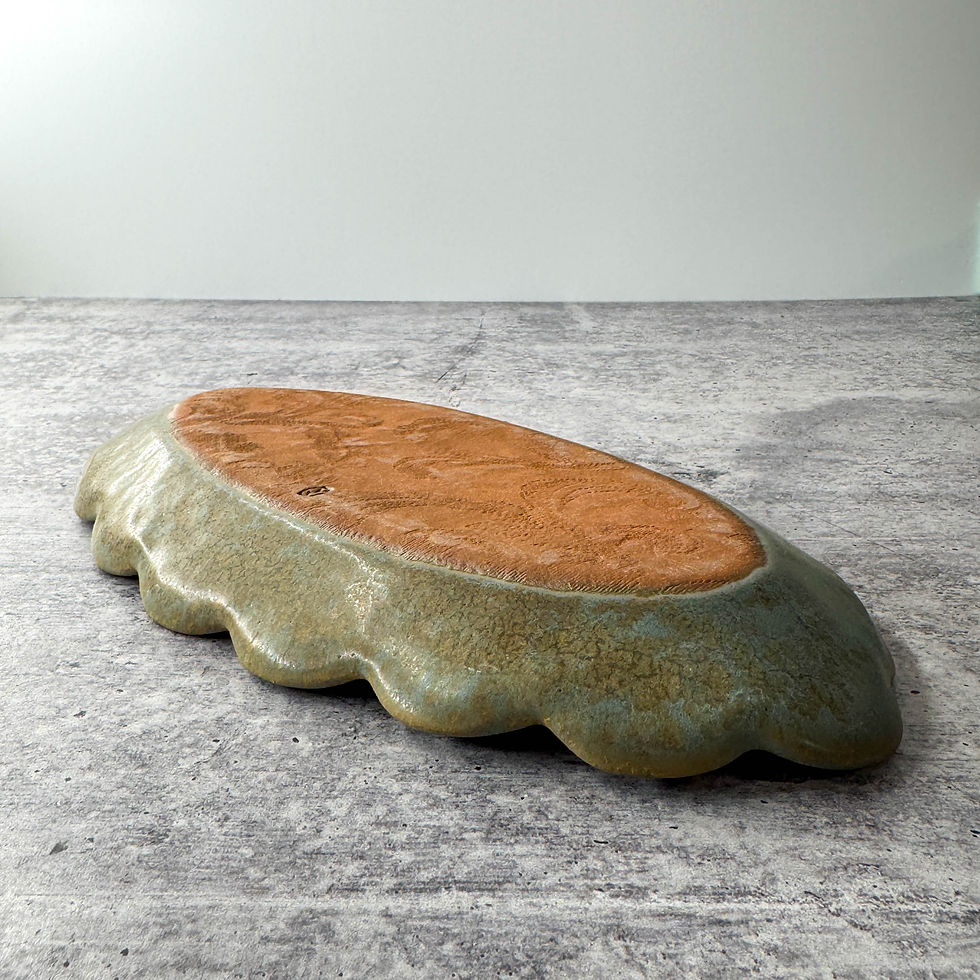 Thumbnail: handmade oval ceramic relish dish with scalloped edge and embossed pine cone and pine bough texture.