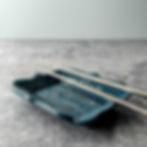 Handcrafted ceramic dish featuring pinecone-inspired surface texture and softly curved form