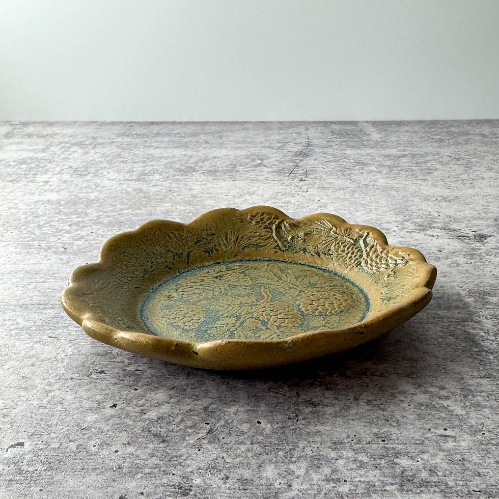 Handmade ceramic tapas or trinket dish with scalloped edges and pine cone texture, crafted from red stoneware with texture