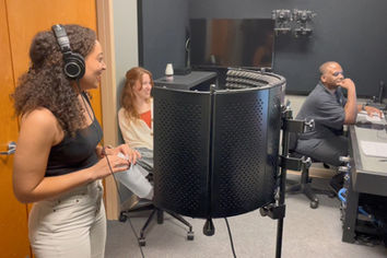Woman with headphones in a recording studio.