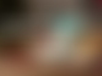 A festive holiday display featuring a bag of Jans Organic Coconut Flour next to fresh coconuts and a variety of gluten-free baked goods like bread and cookies in front of a Christmas tree.