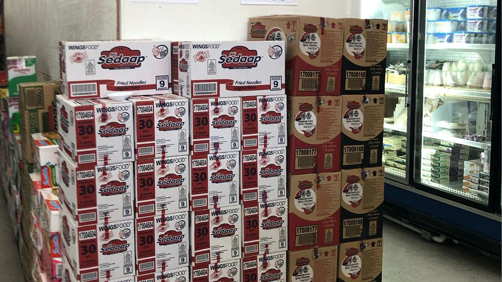 A warehouse or backroom view showing large stacks of Mi Sedaap instant noodle cartons, highlighting Jans' role as a high-volume Asian food distributor.