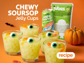Chewy soursop jelly cups decorated with edible eyeballs and pumpkins for a fun, spooky Halloween treat.