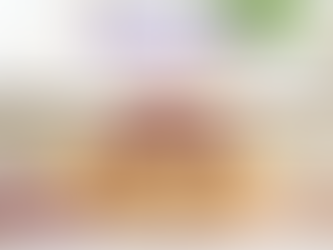 A stack of golden-brown flaky pastries filled with vibrant purple ube, featuring a sliced ube hopia recipe on a wooden board.