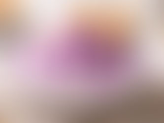 A bowl of fluffy purple ube snow ice cream recipe topped with purple syrup, crushed biscuits, and wafer sticks.