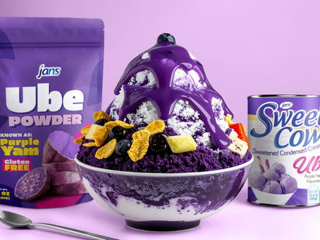 Ube Bingsu dessert topped with purple sauce, fruit, and cereal with Jans Ube Powder and Sweet Cow Creamer in the background.