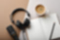 Flat lay composition with Microphone for podcasts and black studio headphones on brown ba