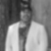 Jason Bulluck, author of piece, wearing a white blazer and baseball cap
