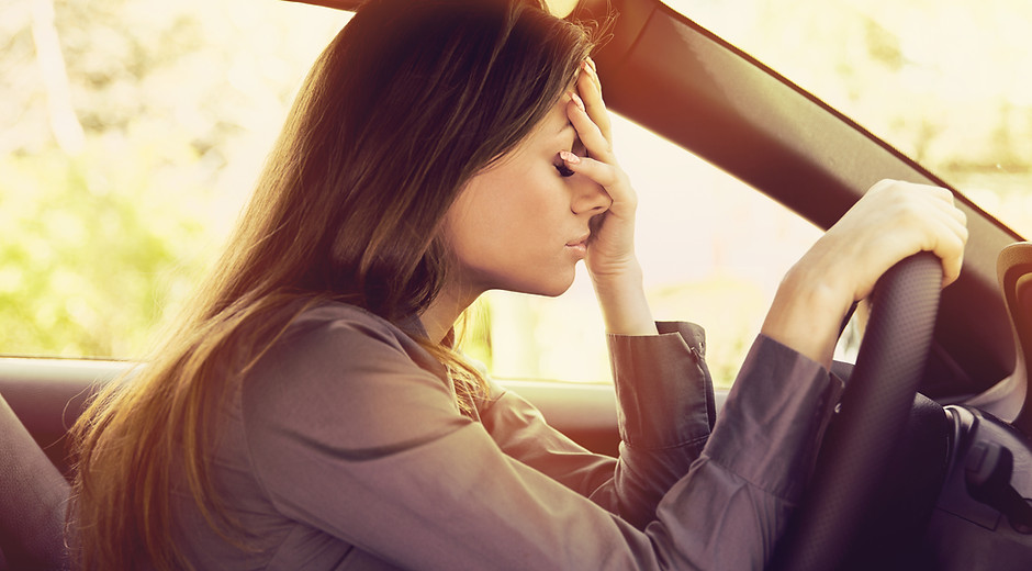 Stressed woman driver sitting inside her car .jpg