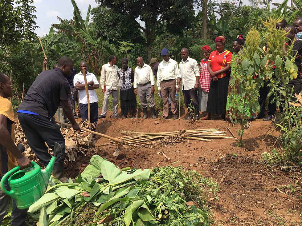 Student intern Peter demonstrates how to correctly make a compost pile that will be utilized for fertilizing the garden beds organically.