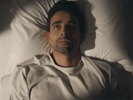 Person lying awake at night with insomnia and racing thoughts