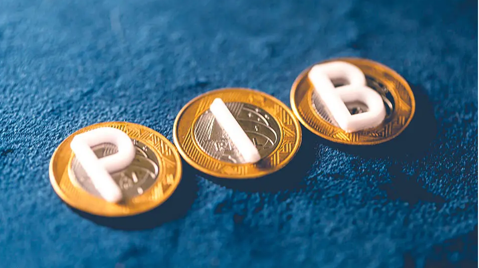 Moedas de um real e letras do PIB