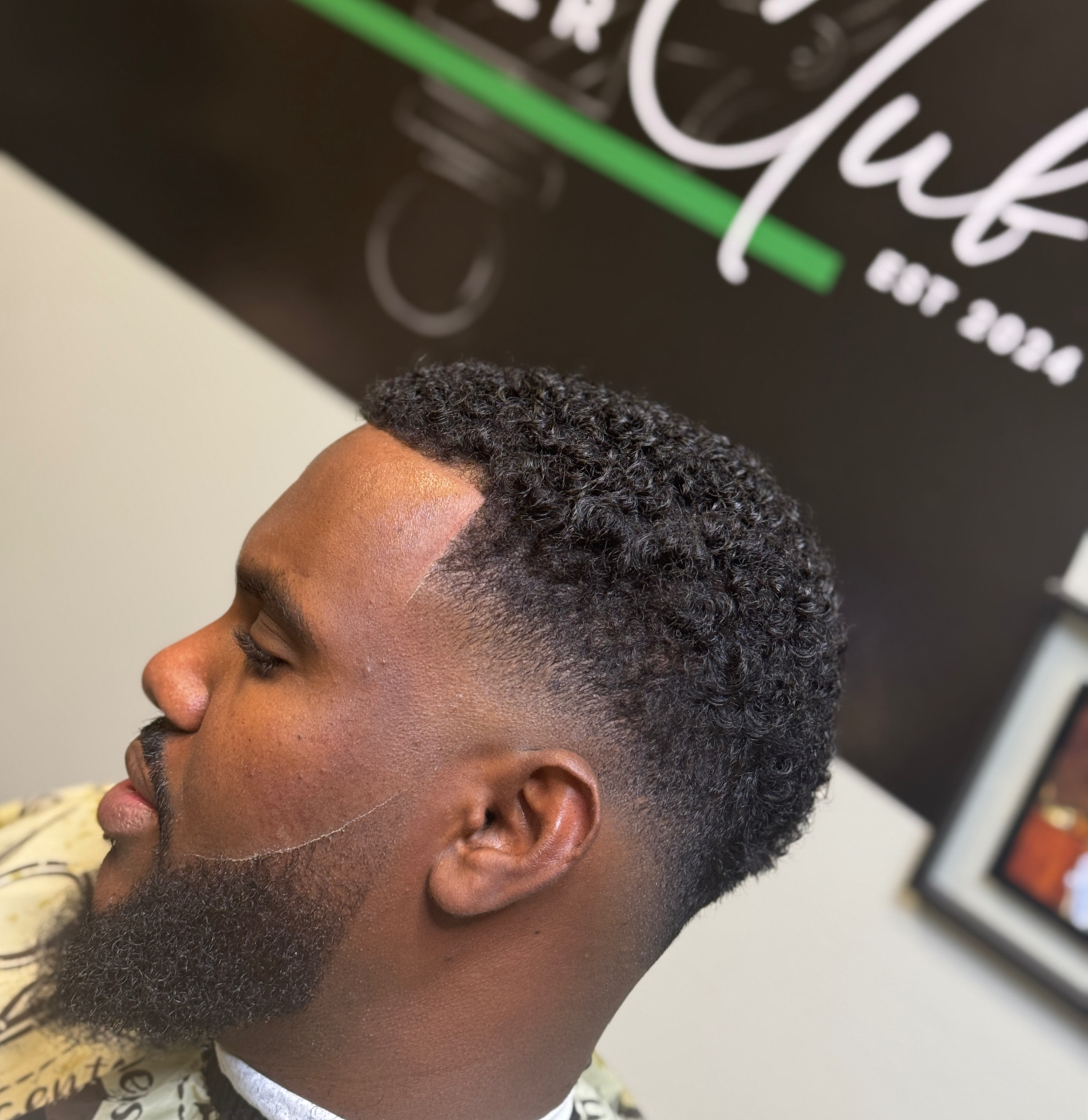 the refresh cut taper tapered haircut on Black African-American male with seamless blend blending and precise line-up crisp edge-up by DthaBarber at The Barber Club MN located inside the Phenix Salon Suites Maple Grove