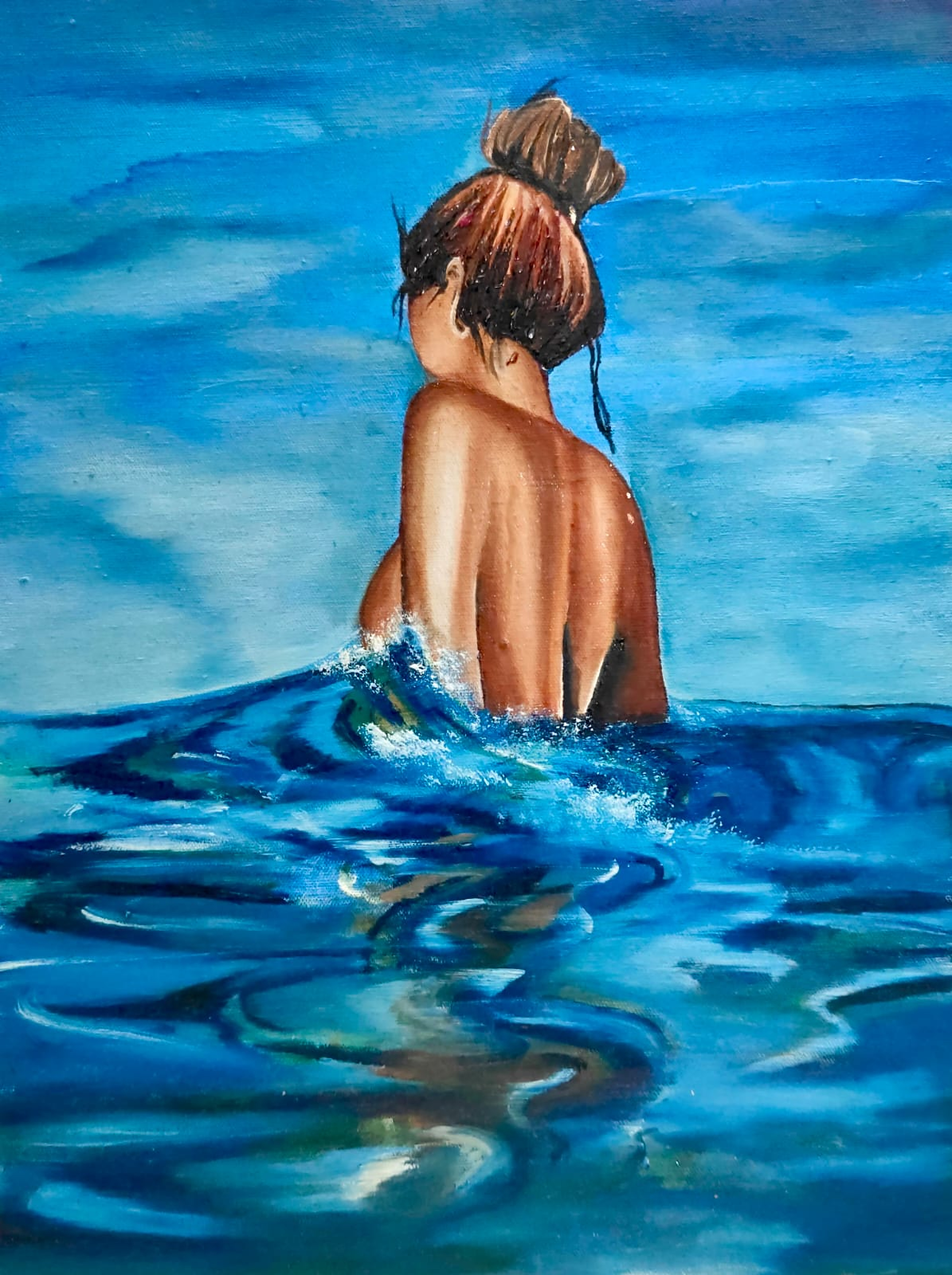 Woman in the ocean by Nisha Dhing, woman partially submerged in ocean