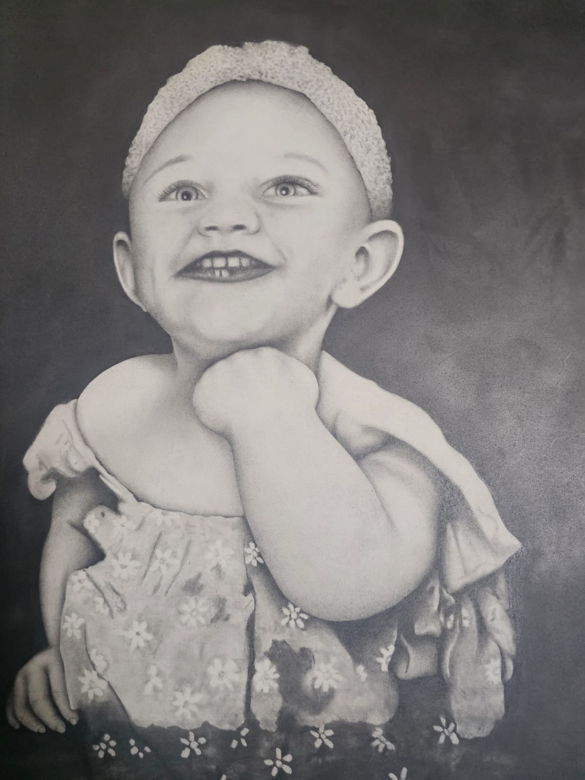 Innocence by Brenda van Zyl, a hyper-realistic portrait of a smiling child in a floral dress