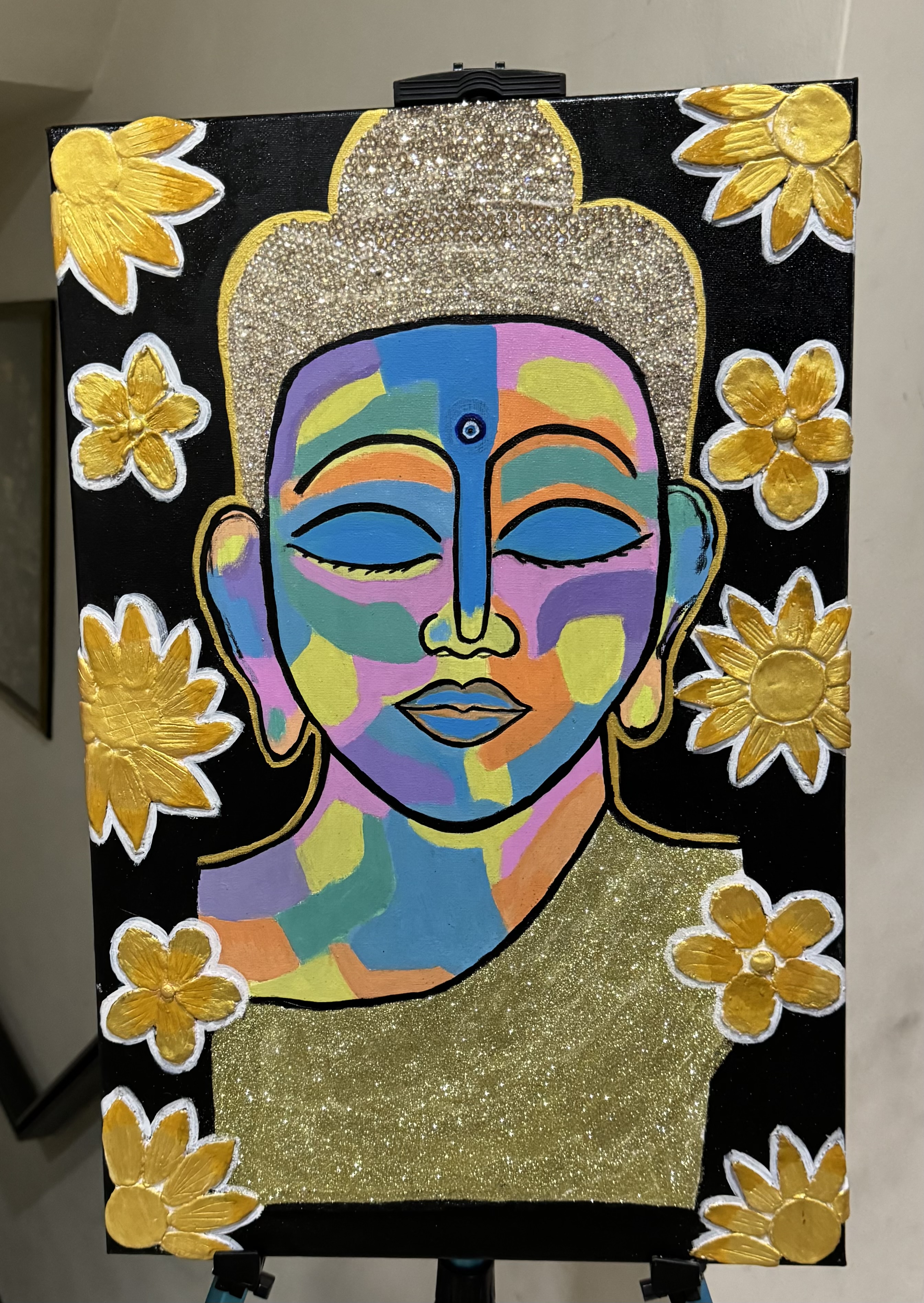 Buddha Beyond Colors by Deviyaa Manimaran, featuring Buddha's face in vibrant colors with golden flowers