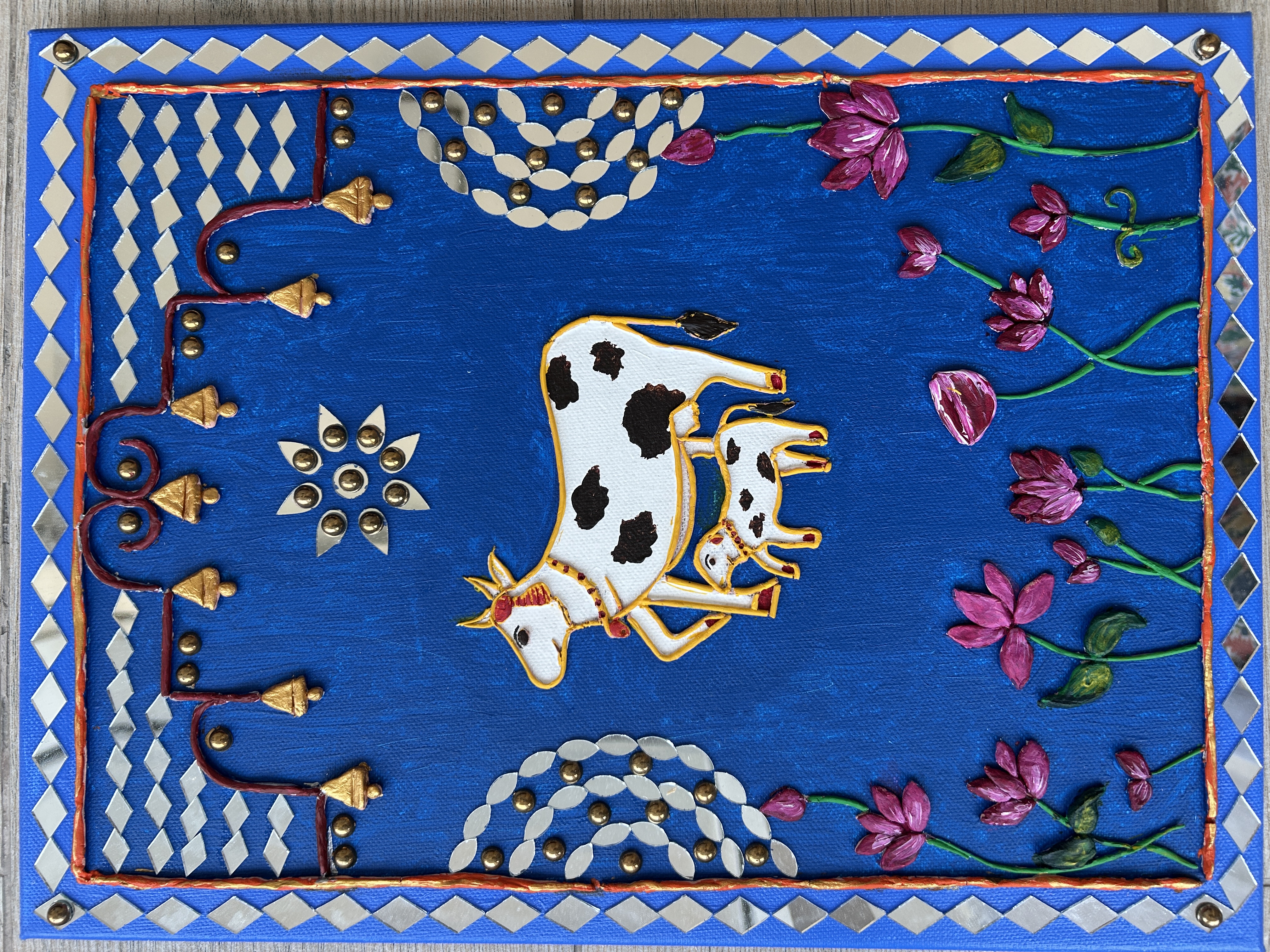 Kamadhenu's Blessing by Sahaj Vanarasi, depicting two cows against a deep blue background