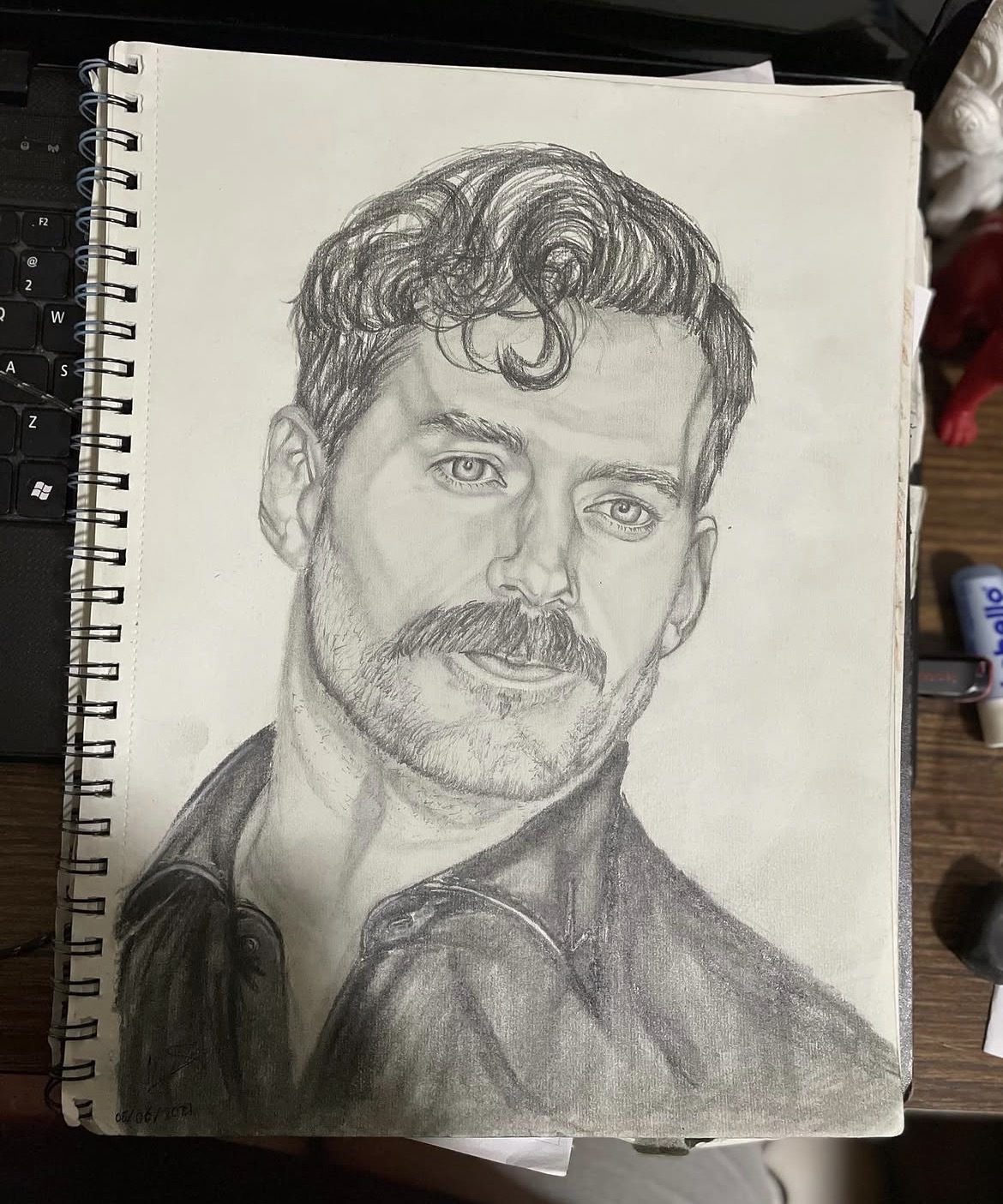 Henry Cavil by Kyra Jade Gopal, graphite drawing of a male figure with wavy hair and a mustache